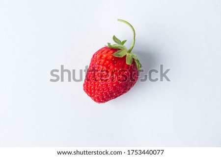 One strawberry on a white background. Photo from above. Creative photo of strawberries