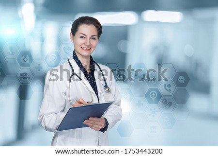 The doctor writes down the patient's medical history on a blurred background.