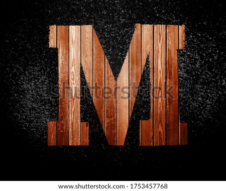 Latin letters made of wooden planks on a black background