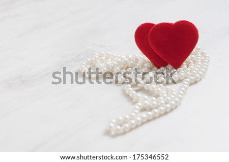two plush hearts on the pearls necklaces