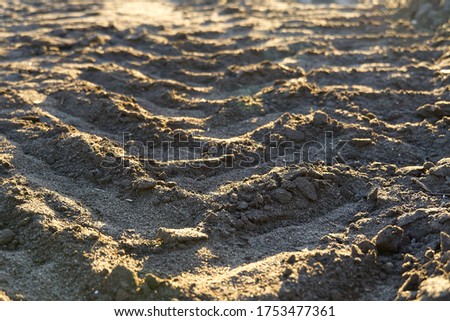 Excavator tracks on the ground texture. Mud ground earth soil trace tracks marks markings dry surface texture.