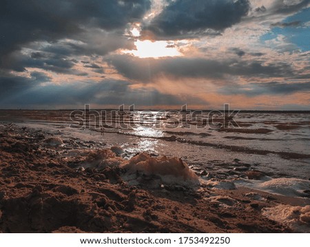 Sunset cloudy sky with picturesque clouds lit by warm sunset sunlight, colorful sunset sky with dramatic sky clouds lit by evening sunlight. Country road at sunset