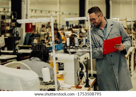 The manager makes an inventory of the leather and supplies that are missing in the factory.Manager at a leather shoe manufacturing factory