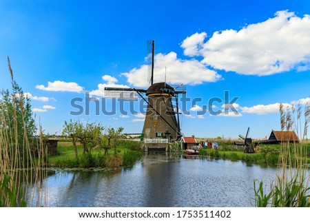 Old windmill on dutch landscape, Kinderdijk is a village in the municipality of Molenlanden, in the province of South Holland, Netherlands
