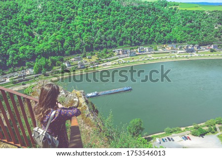 Summer sunny lifestyle fashion portrait of young stylish hipster woman walking in mountains, wearing cute trendy outfit, smiling enjoy weekends, travel with backpack. awesome water, river view