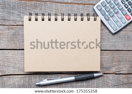 Calculator, pen and notebook on wooden table, education objects 