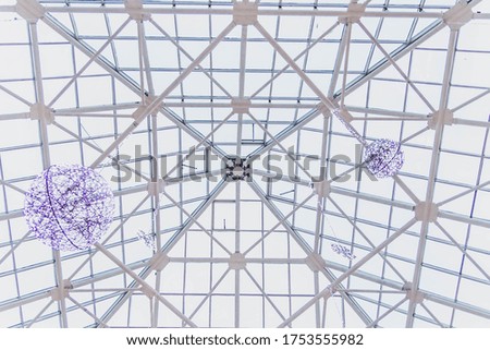 The transparent roof of the shopping center is decorated with huge balloons and glowing led garlands. copy space. Background.