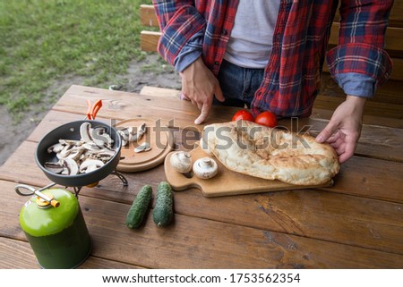 a variety of vegetables, cucumbers, tomatoes, mushrooms and pita for cooking dinner in nature at the campsite