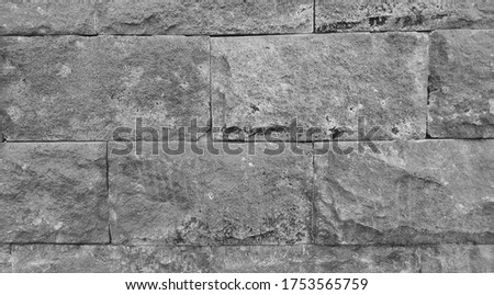 Marble wall with abstract texture. There appears to be grass trying to grow between the rocks. Images suitable for use as wallpaper, background, or graphic resources