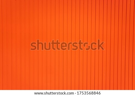 Red metallic background of parallel vertical lines