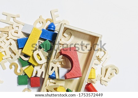 Collection of wooden alphabet letters and colourful multicoloured building wooden toy blocks geometric for kid learning development school education. Education, creative, logical thinking concept.