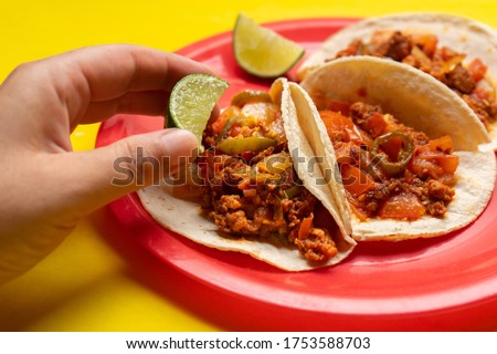 Traditional mexican chorizo tacos on yellow background