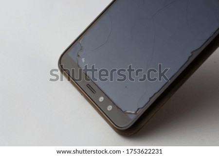 Broken phone on grey background