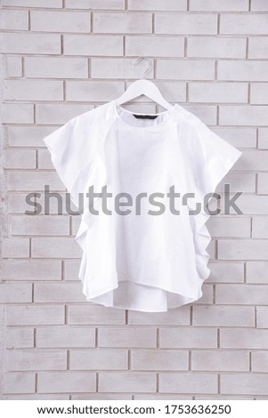 female,white blouses shirt isolated on hanging
