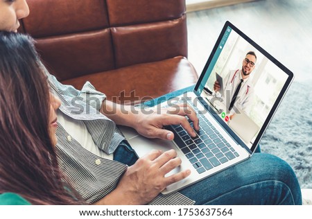 Doctor telemedicine service online video for virtual patient health medical chat . Remote doctor healthcare consultant from home using online mobile device connect to internet for live video call . Royalty-Free Stock Photo #1753637564