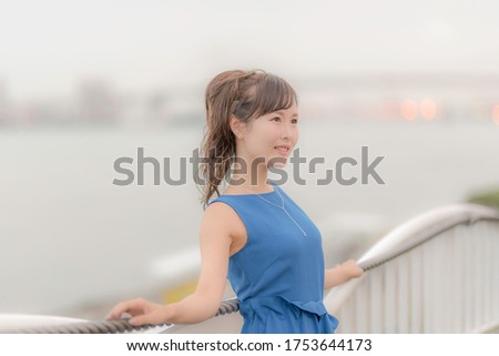 Japanese woman posing against the sea