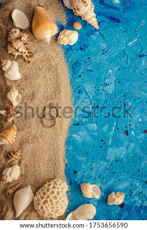 wedding rings on sand stylistic pacific wedding abstract summer background