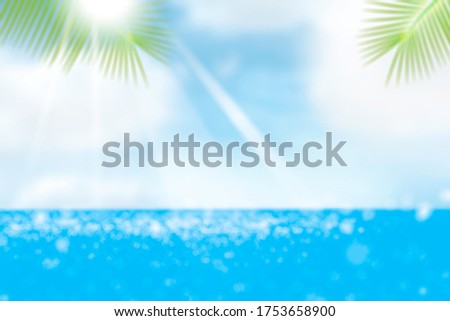 Abstract blurred photo of beach,Blur beautiful nature green palm leaf on tropical beach with bokeh sun light wave abstract background,Concepts, colors and relaxing atmosphere