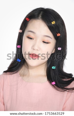 a beautiful Korean woman wearing a pink dress with a rainbow pin