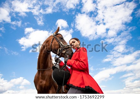 Fashion photo Equestrian sport Woman jockey with brown horse, outdoors.