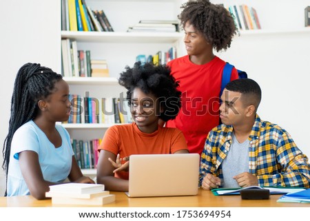 Group of african american and latin students coding app at computer at classroom of university
