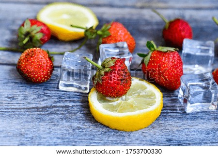 Summer refreshment detox  drink ingredients.Fresh cool drink of ripe juicy  strawberry ,ice cubes and lemon. Vitamin C concept. 