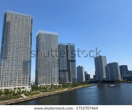 Skyscrapers over the canal under the blue sky on a sunny day in Japan