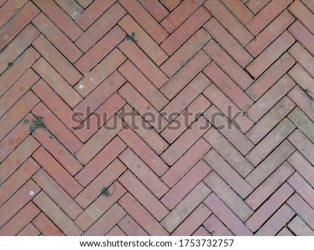 The brick floor is laid in a zigzag shape.