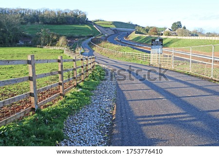 Shadows of a fence on a country road	