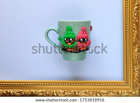 The original mug with decorative figurines made with their own hands. A lovely birthday present. Figures on the cup are fashioned hand made from colored clay. Stand in golden frame. High quality photo