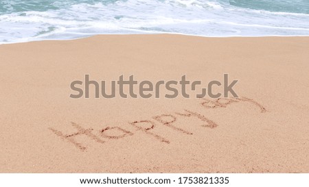 Inscription on sand "Happy day"
Close-up of sand with the inscription on a background of the sea wave. Everyday concept.