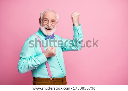Profile photo of funky crazy grandpa raise fists ecstatic good mood cool achievement wear specs mint shirt suspenders violet bow tie trousers isolated pink pastel color background Royalty-Free Stock Photo #1753855736