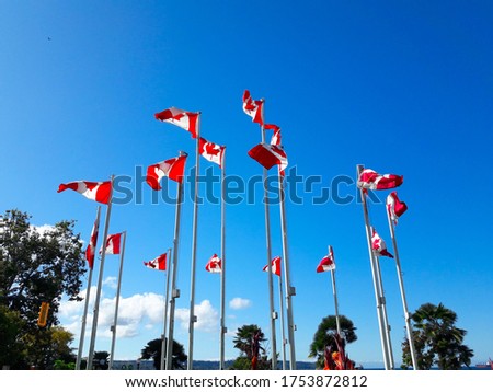 Canada flags in front of blue sky, Vancouver, Canada