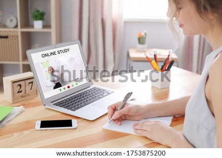 Young woman using laptop for online studying at home, closeup