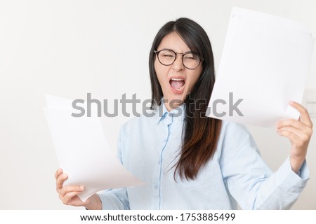 Worried businesswoman reading paper Earnings report on white background.