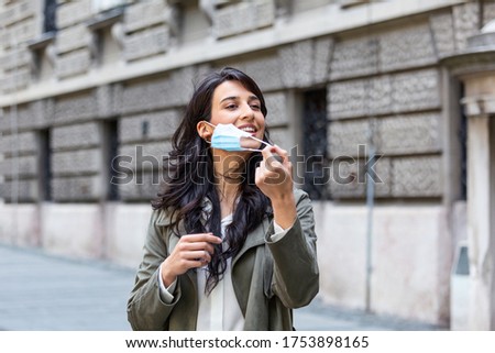 Quarantine is over concept. Woman taking off mask outdoor. We are safe. Coronavirus ended. We won. No more quarantine. Breathe deep. Take off the mask. Coronavirus is over Royalty-Free Stock Photo #1753898165