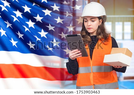 Girl works in USA. Customs. Girl in working uniform on the background of USA flag. American works at customs. US Customs Officer. Girl holds a tablet and boxes. Woman registering parcels using tablet