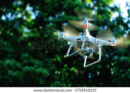 White drone with camera flying taking pictures of lychee fruits  in summer