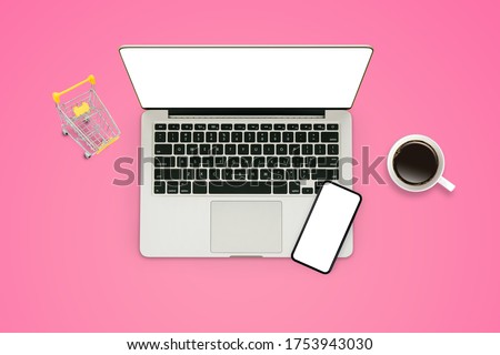 Shopping Online Concept : Top view of Laptop, smartphone, yellow shopping cart and coffee cup put on pink background.