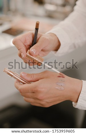 Stock Photo - Hands with make-up brushes and beauty cosmetics
