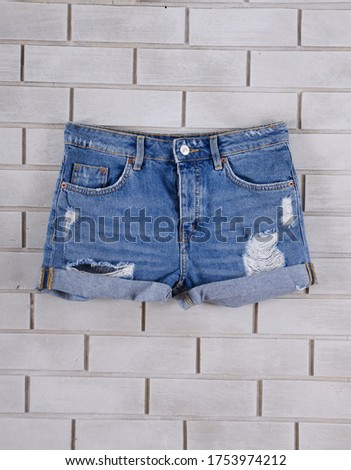Women's Blue jeans torn shorts on white background.

