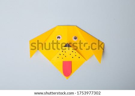 Step by step photo instruction. How to make origami paper dog. DIY for children. Children's art project craft for kids