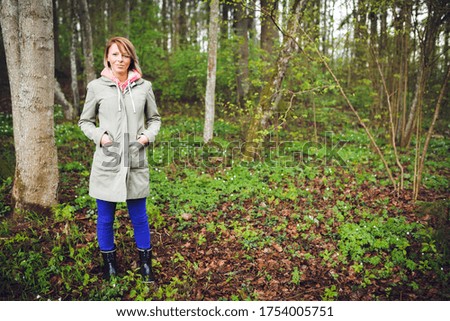 Outdoor portrait of a young cute woman in a forest, natural light.