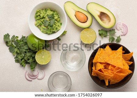 Guacamole, corn chips and beer, light Mexican snack or dinner