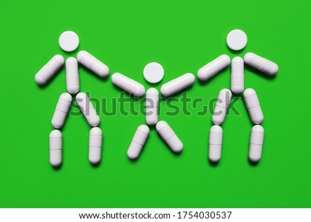 three people from tablets on a green background, the concept of family treatment and protection against diseases, medical concept, medicine for coronavirus, vitamins for immunity, pills for every day