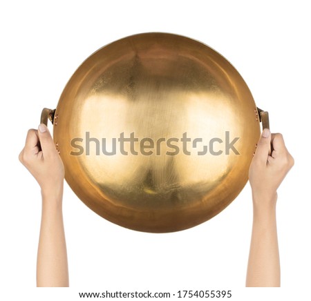 Hand holding Brass pan isolated on a white background Royalty-Free Stock Photo #1754055395