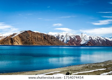 Pangong Lake in Ladakh, India - Snow mountains of Ladakh. Panoramic peak views of Himalayas. Natural beauty of Ladakh in India. Famous tourist place in the world Travel & Landscape photography. Nature Royalty-Free Stock Photo #1754074454