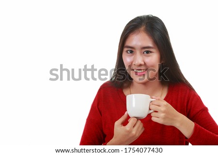 Young Asian teeenager in red casual shirt holding coffee cup drinking on white background with copy space