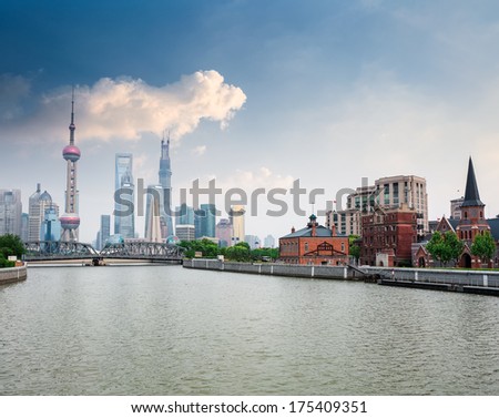 beautiful suzhou river with shanghai skyline against a blue sky 
