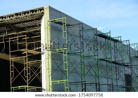 Scaffolders beside building support safety working area.Clear blue sky no cloud background.Concept of Industrial.
